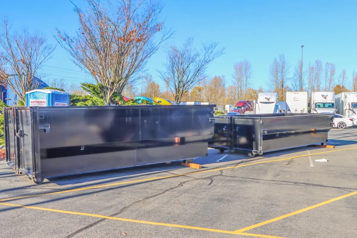 Professional dumpster rental service with roll-off container on residential driveway in Hybla Valley